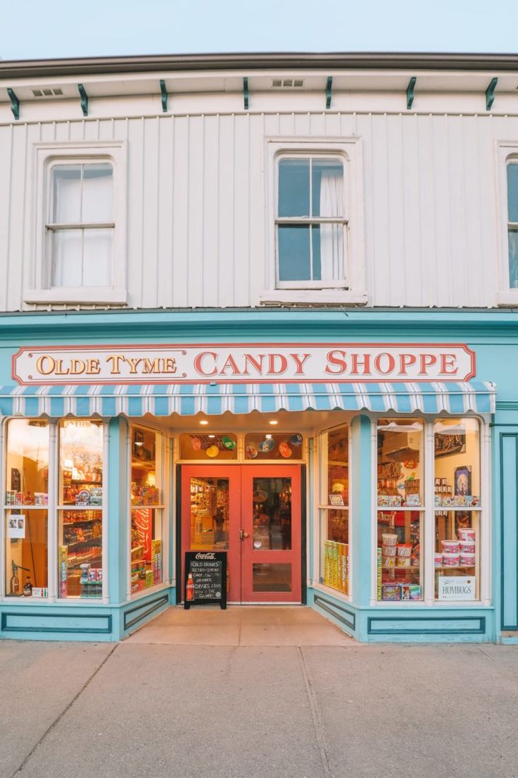 Olde Tyme Candy Shoppe storefront with a blue and white striped awning.